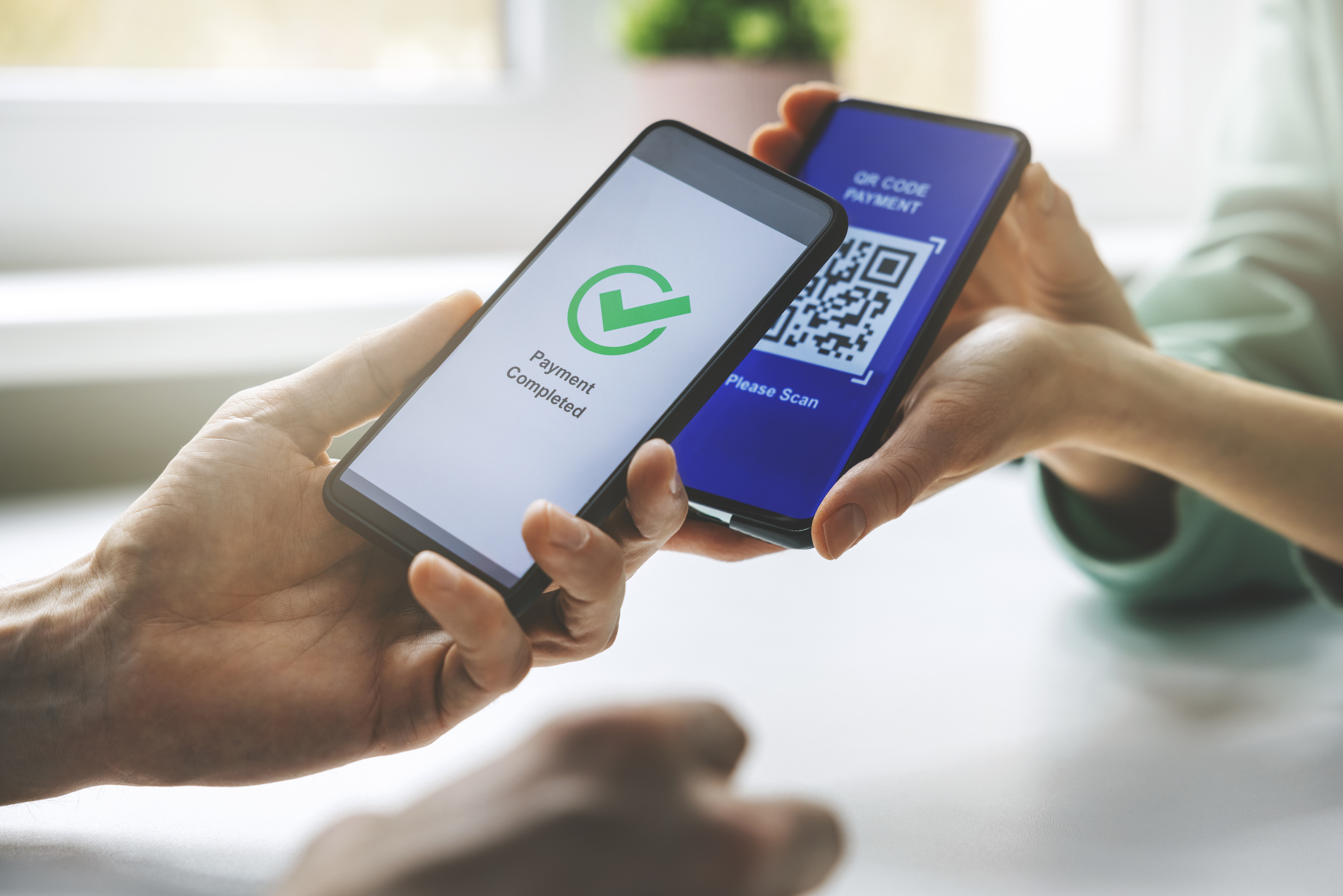 qr code payment - person paying with mobile phone