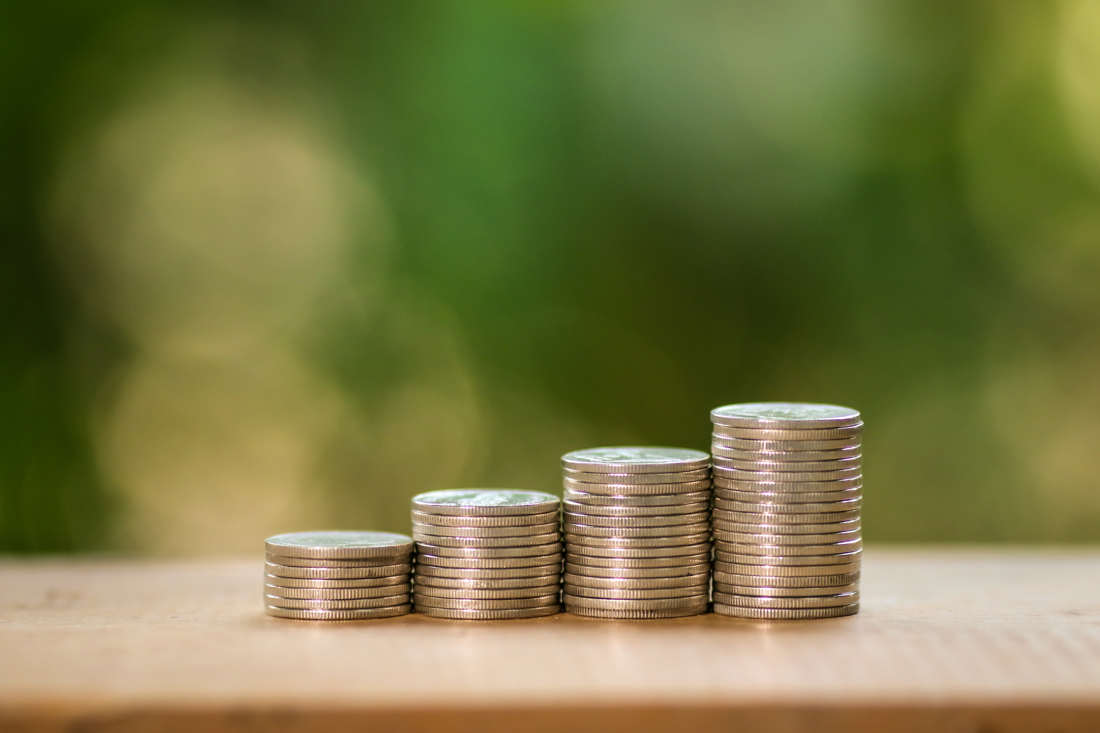 Silver Round Coins on Brown Wooden Table